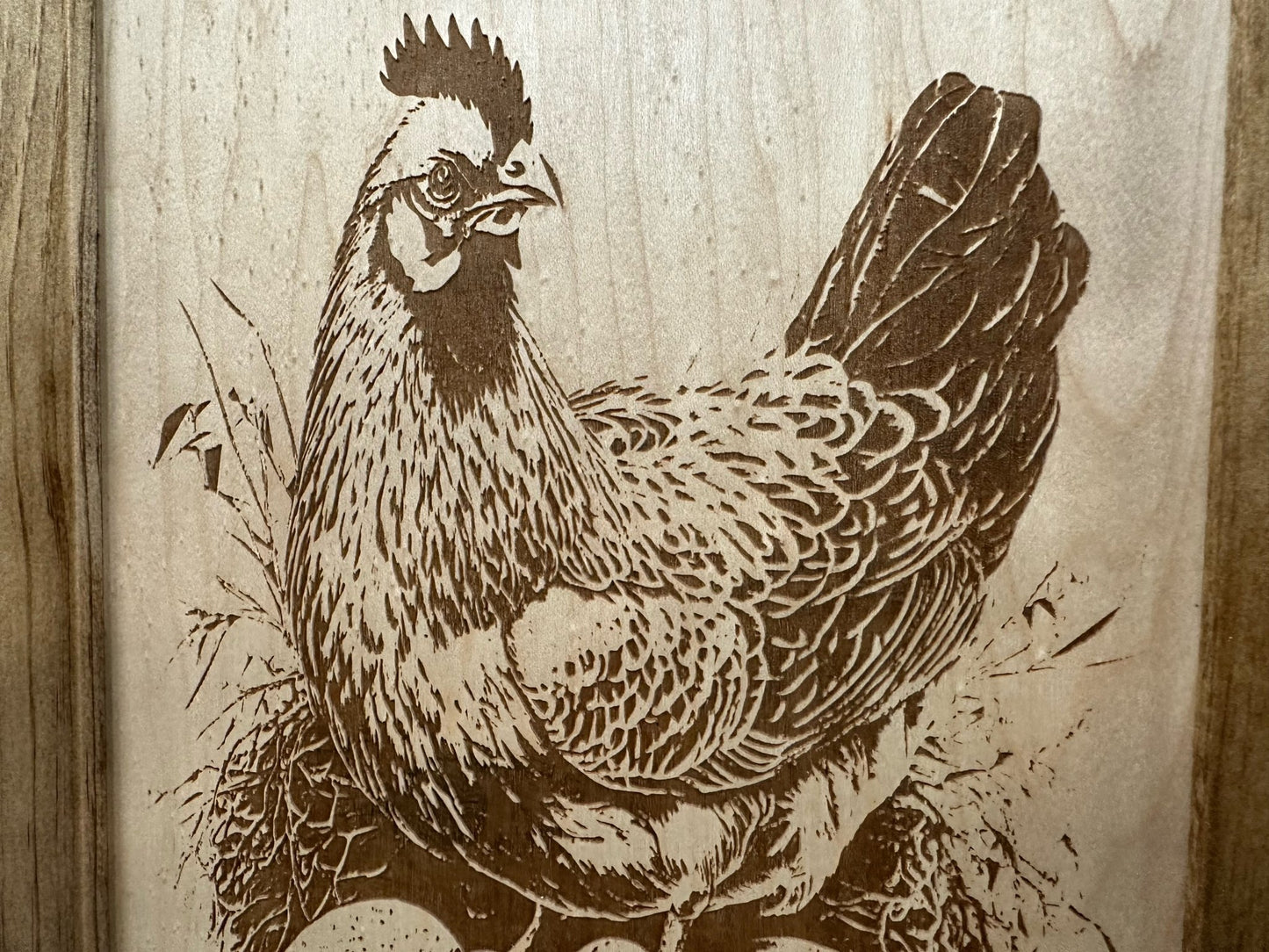 Engraved illustration of a rooster on a wooden background