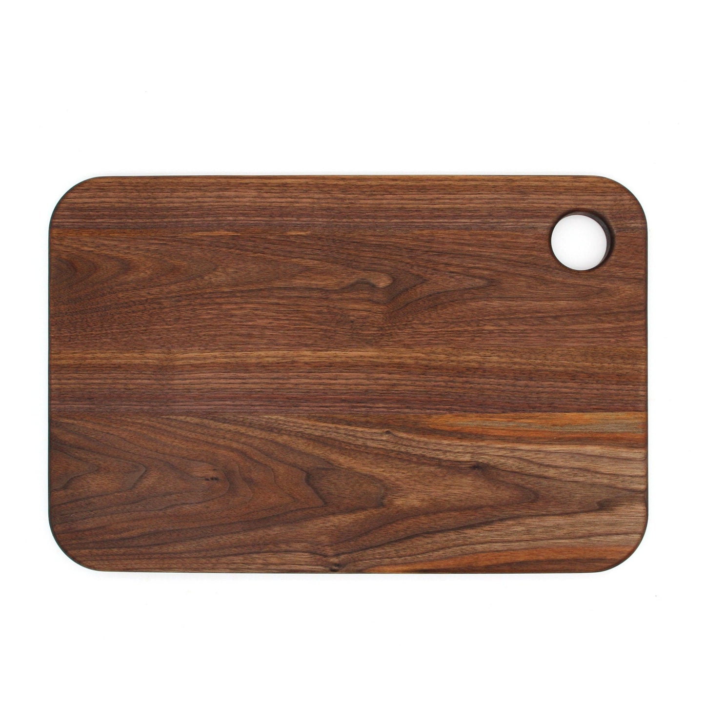 Wooden cutting board with a round hole on a white background