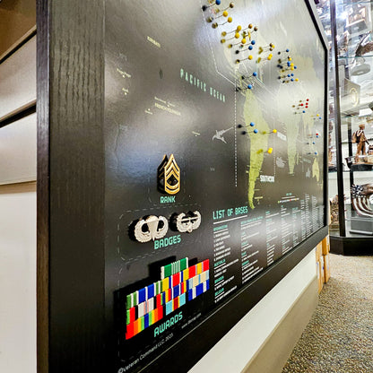 Display board with military rank insignia, badges, and a map of the Pacific Ocean.
