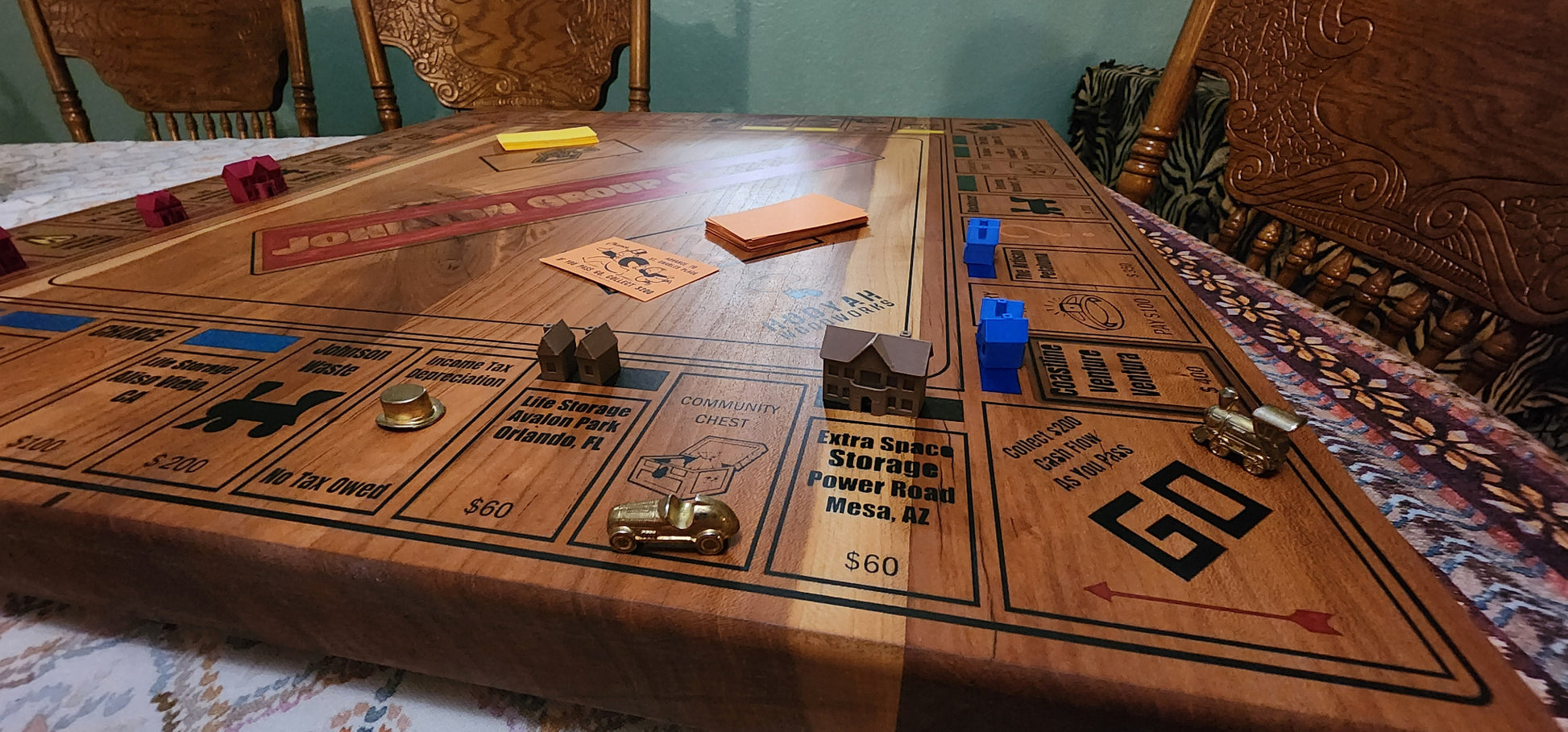 Wooden board game on a table with chairs around