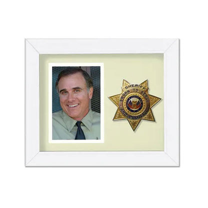 Framed photo of a smiling man with a sheriff's badge on a white background