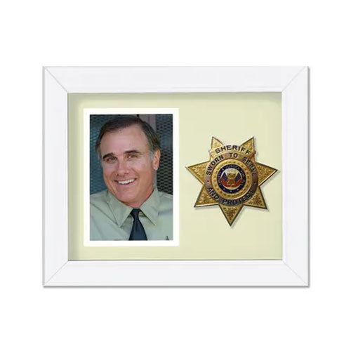 Framed photo of a smiling man with a sheriff's badge on a white background