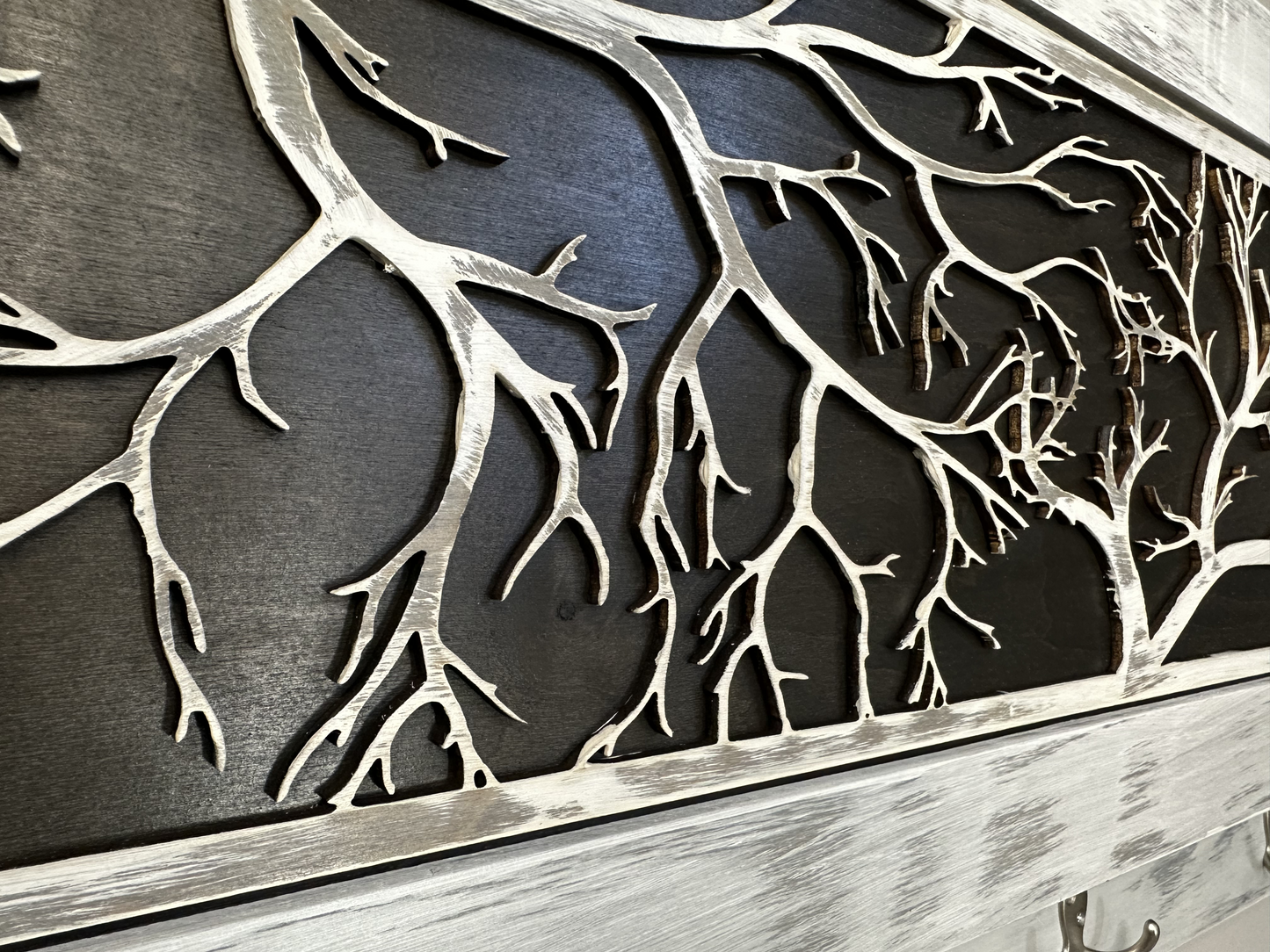 Metallic tree branch design on a dark background