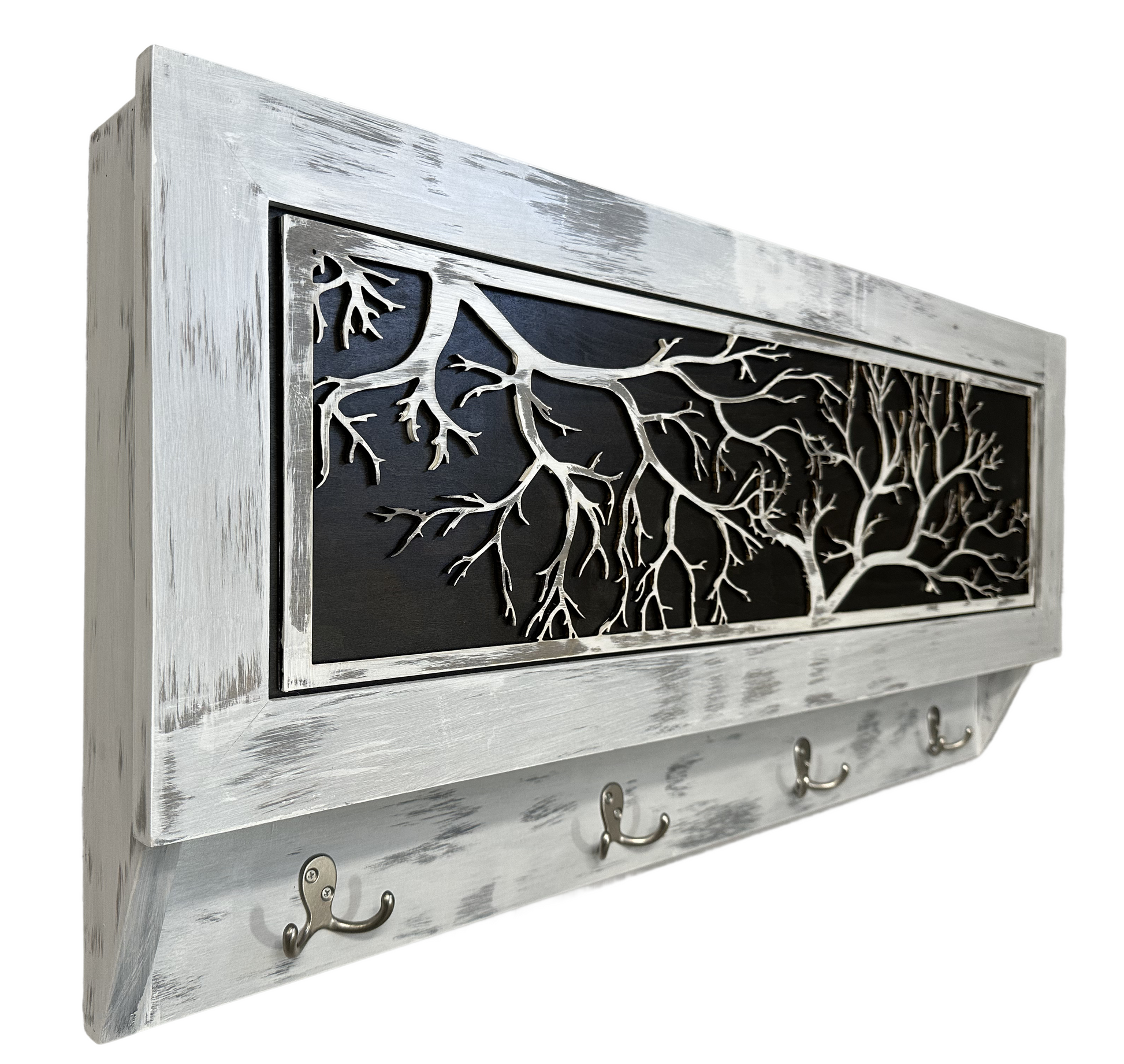 Decorative wall hook with tree branch design and whitewashed wooden frame.