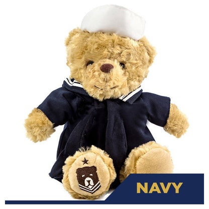 Teddy bear in navy uniform with a white hat on a white background