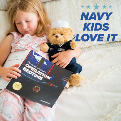 Child holding a book titled 'Operation Bedtime' with a teddy bear wearing a navy uniform on a white blanket.