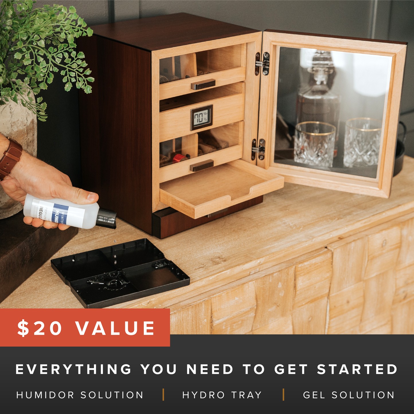 Wooden humidor with open door on a wooden surface, hand holding a bottle labeled '$20 Value'.