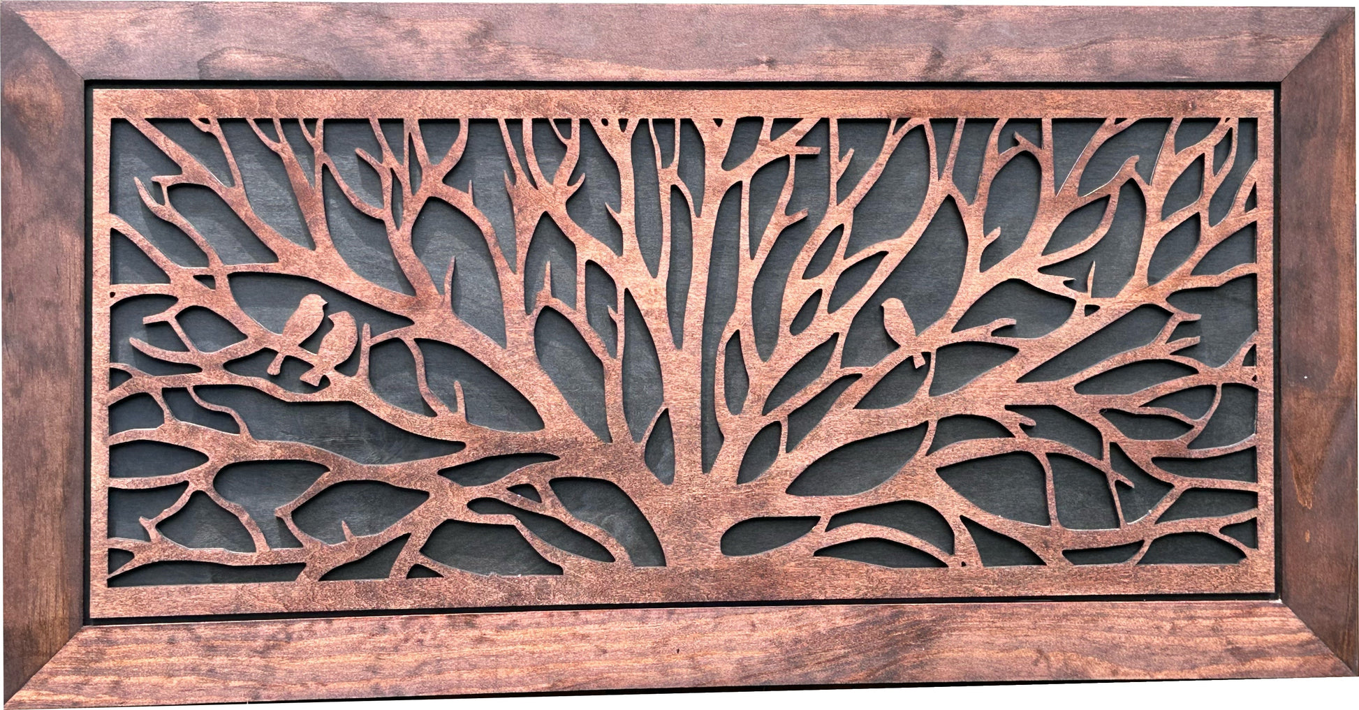 Decorative metal grille with tree design and wooden frame