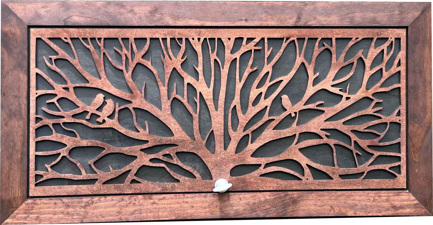Decorative metal grille with tree design and wooden frame