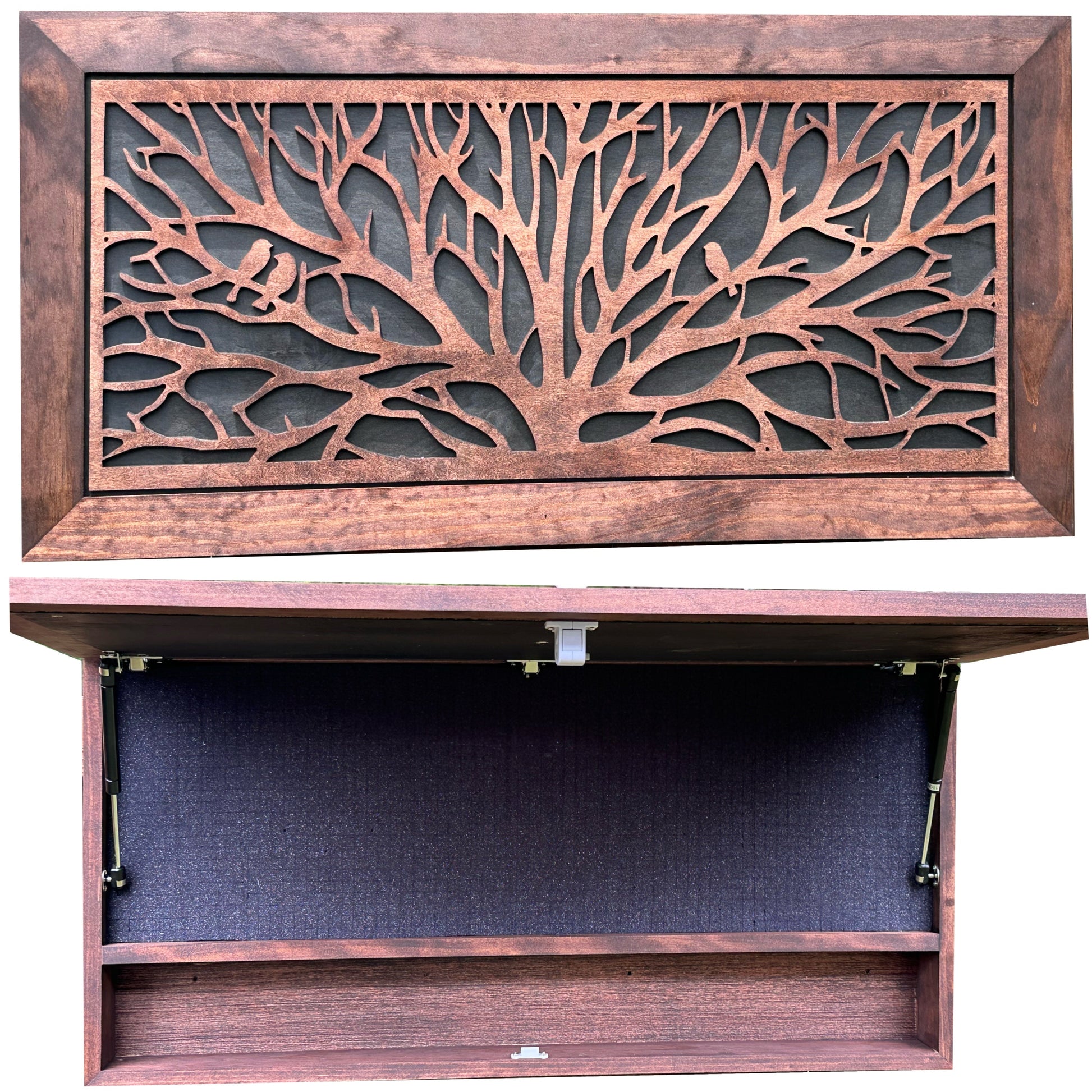 Wooden cabinet with decorative tree design on the door, open to reveal a dark interior.