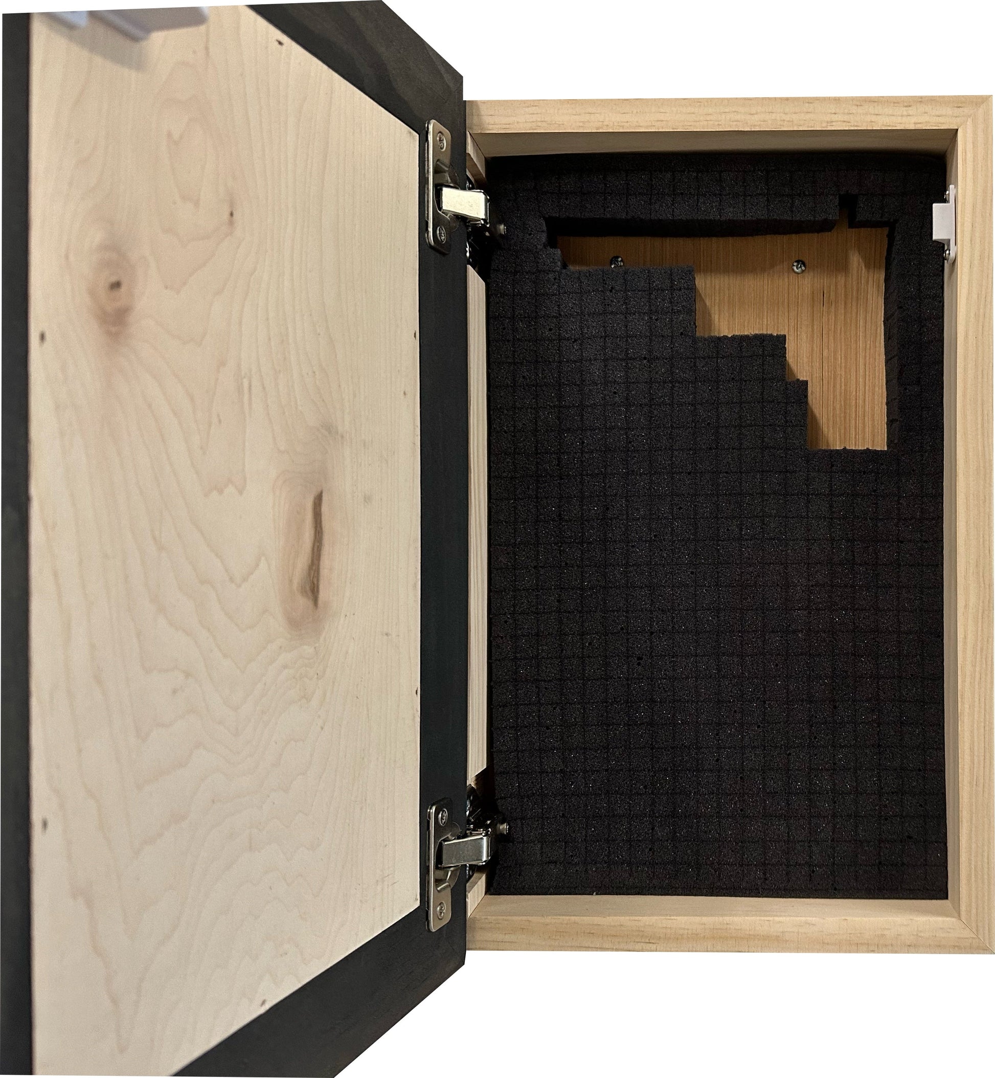 Wooden cabinet with one door open, revealing black soundproofing material inside.