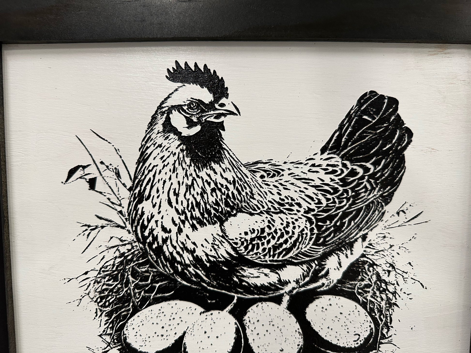 Black and white illustration of a chicken with eggs on a textured background