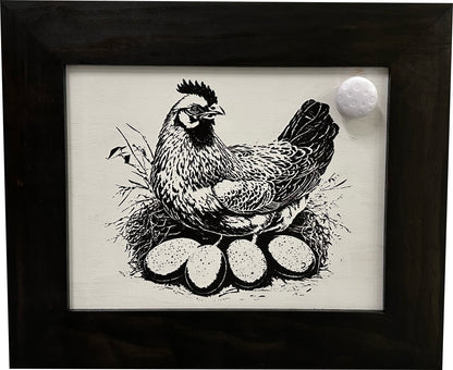 Framed artwork of a chicken with eggs on a white background