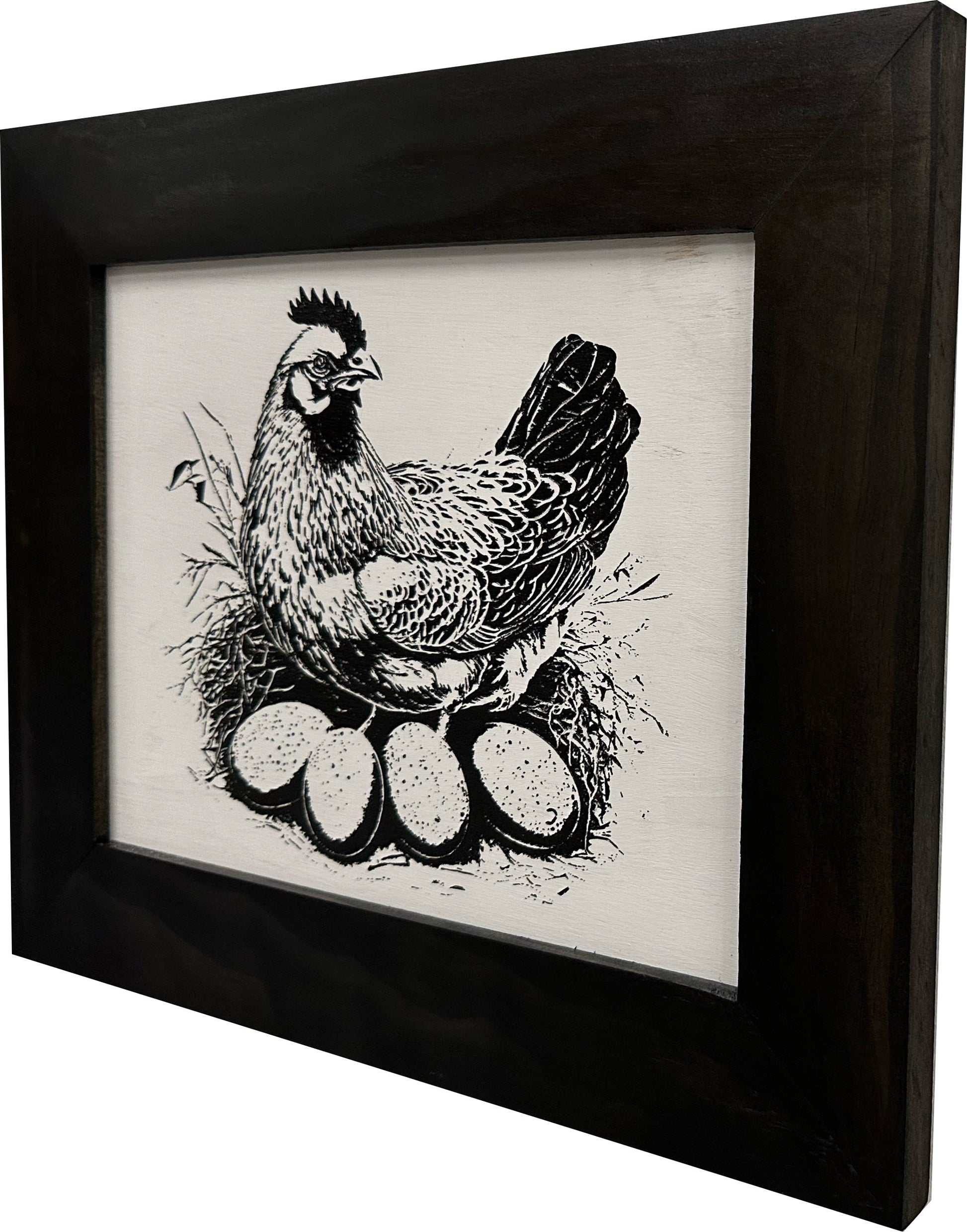 Framed artwork of a chicken with eggs on a white background