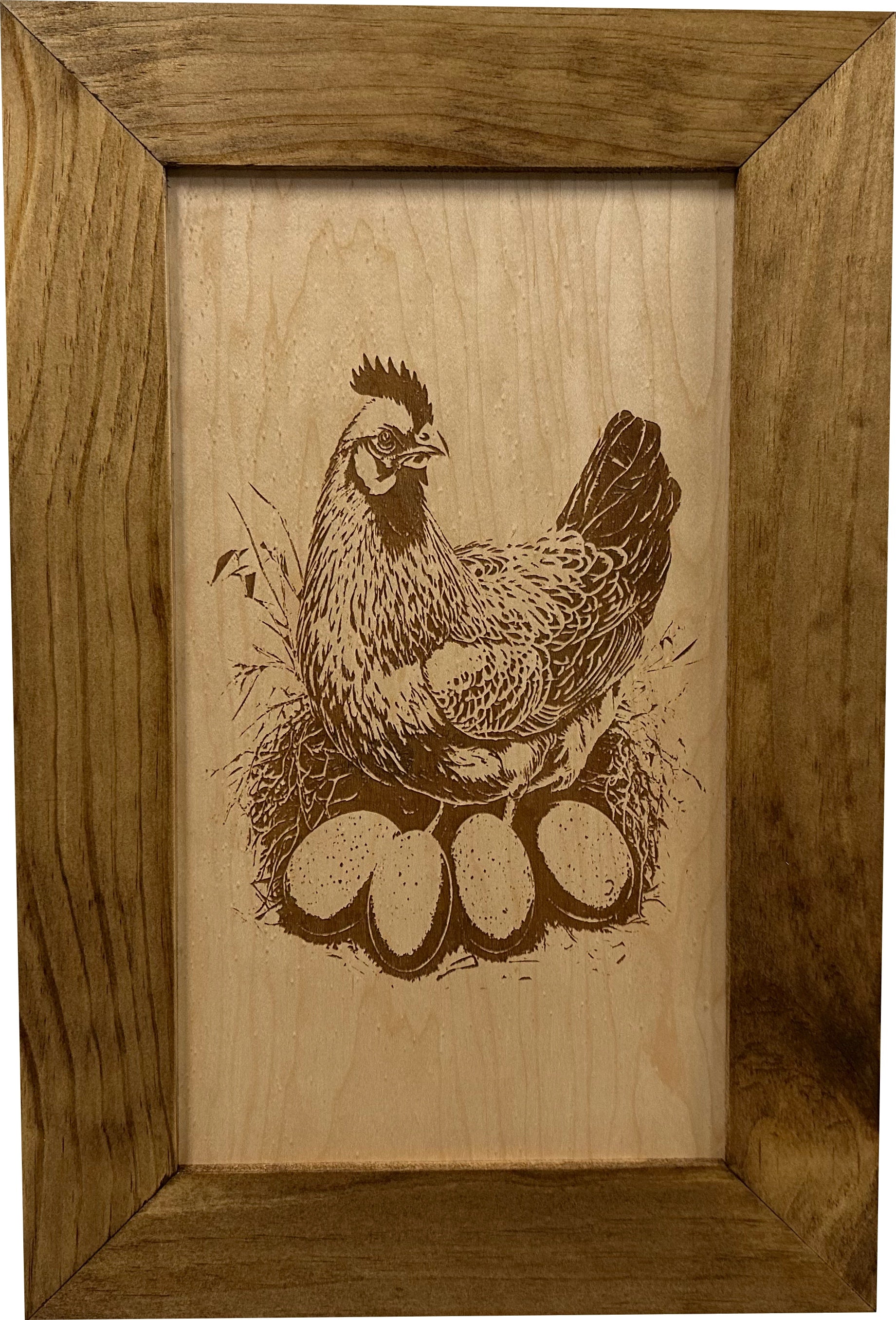 Wooden frame with a engraved illustration of a chicken and eggs