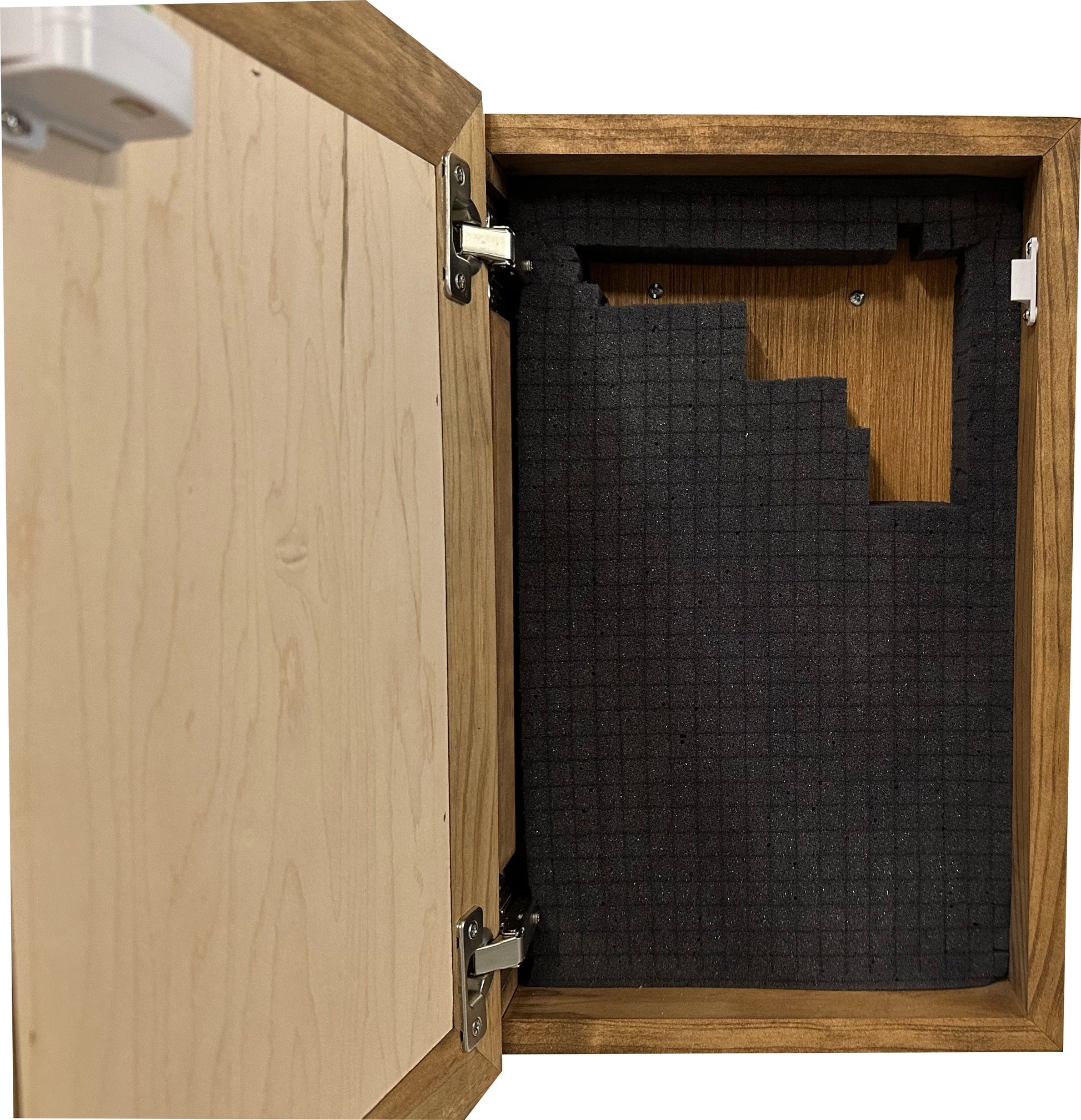 Wooden cabinet with open door revealing black honeycomb soundproofing material inside.
