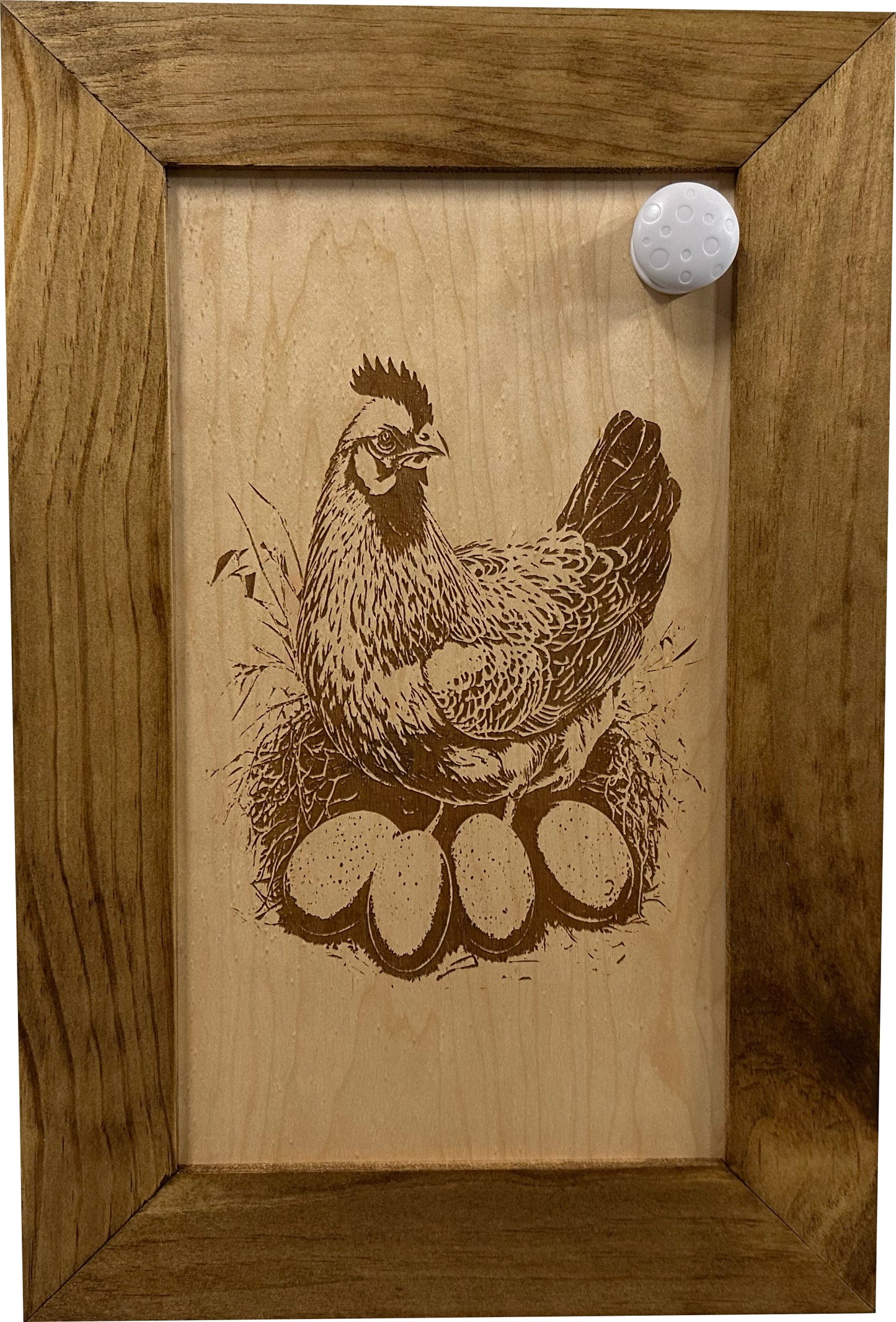 Wooden plaque with a chicken and eggs engraving in a wooden frame.