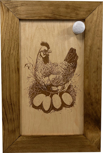 Wooden plaque with a chicken and eggs engraving in a wooden frame.