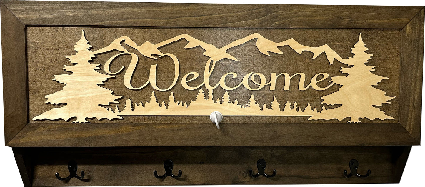 Wooden wall decoration with 'Welcome' and mountain silhouette