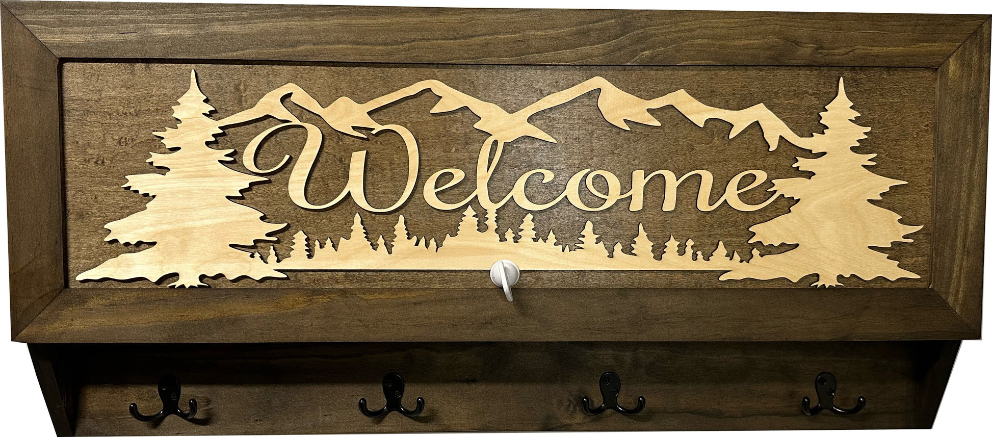 Wooden wall decoration with 'Welcome' and mountain silhouette
