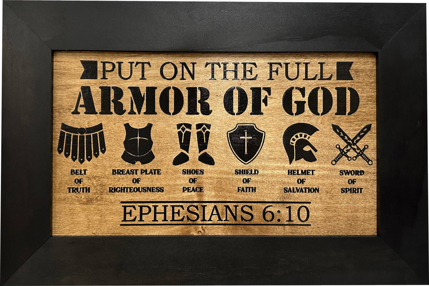 Wooden plaque with armor of God symbols and text on a black background