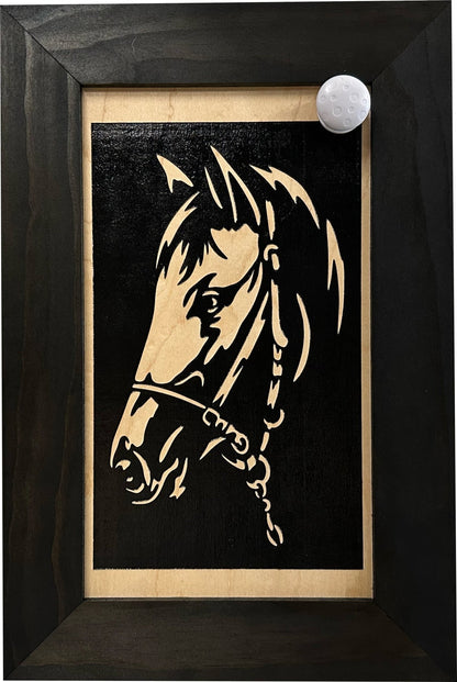 Framed artwork of a horse's head on a black background