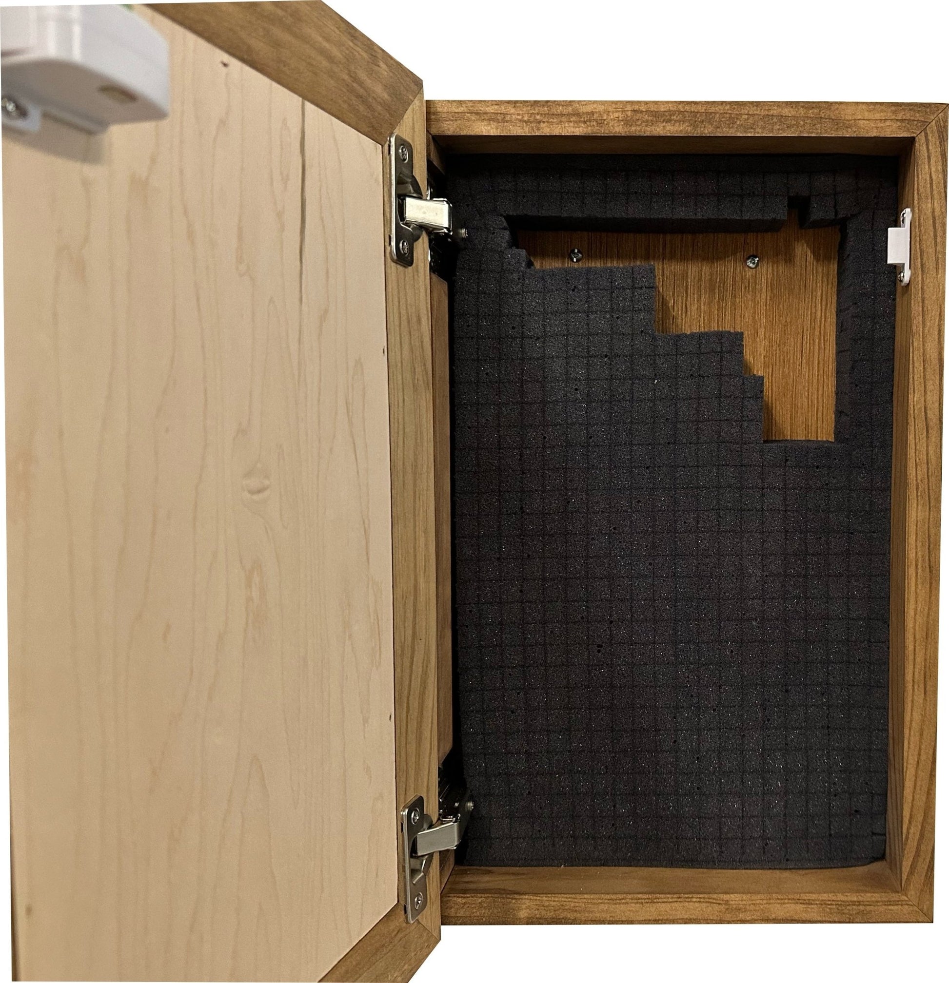 Wooden cabinet with open door revealing black honeycomb soundproofing material inside.