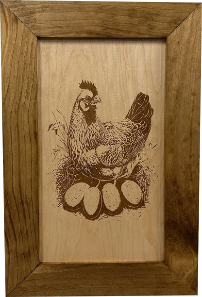 Wooden frame with a engraved illustration of a chicken and eggs