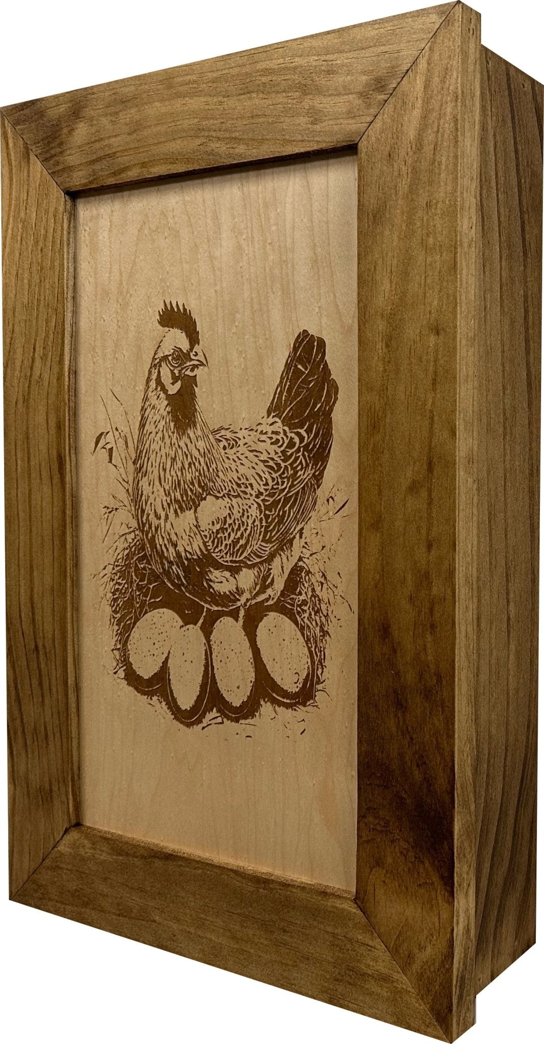 Wooden box with a engraved design of a rooster on a white background