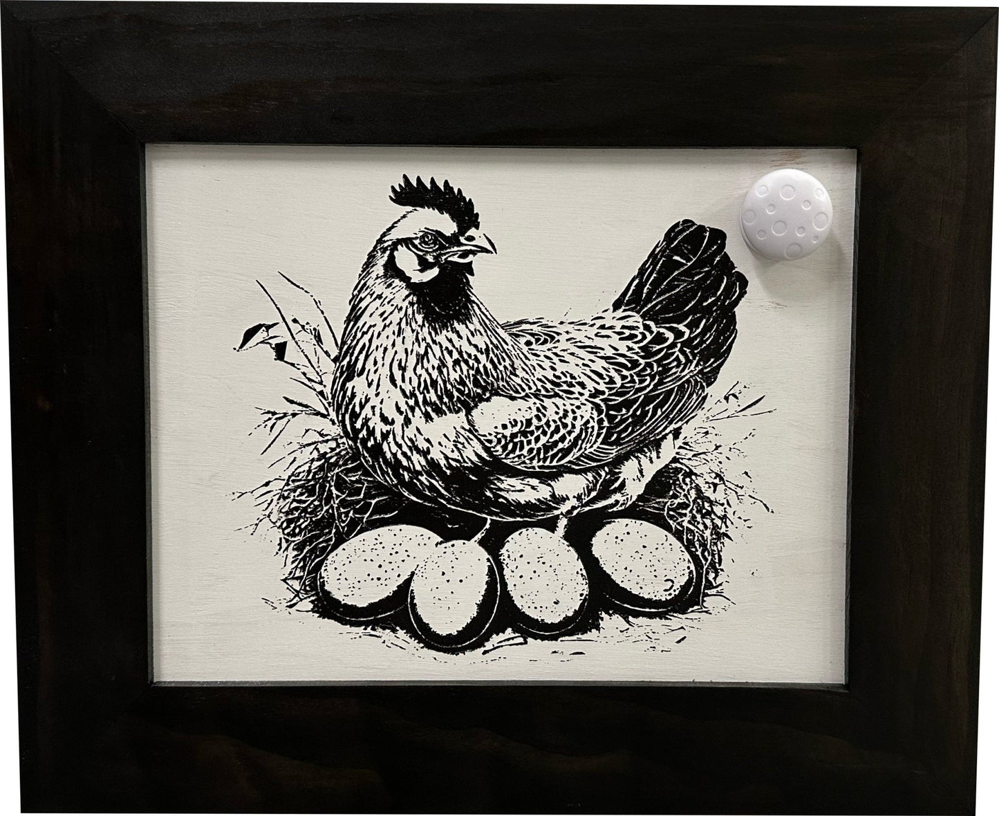Framed artwork of a chicken with eggs on a white background