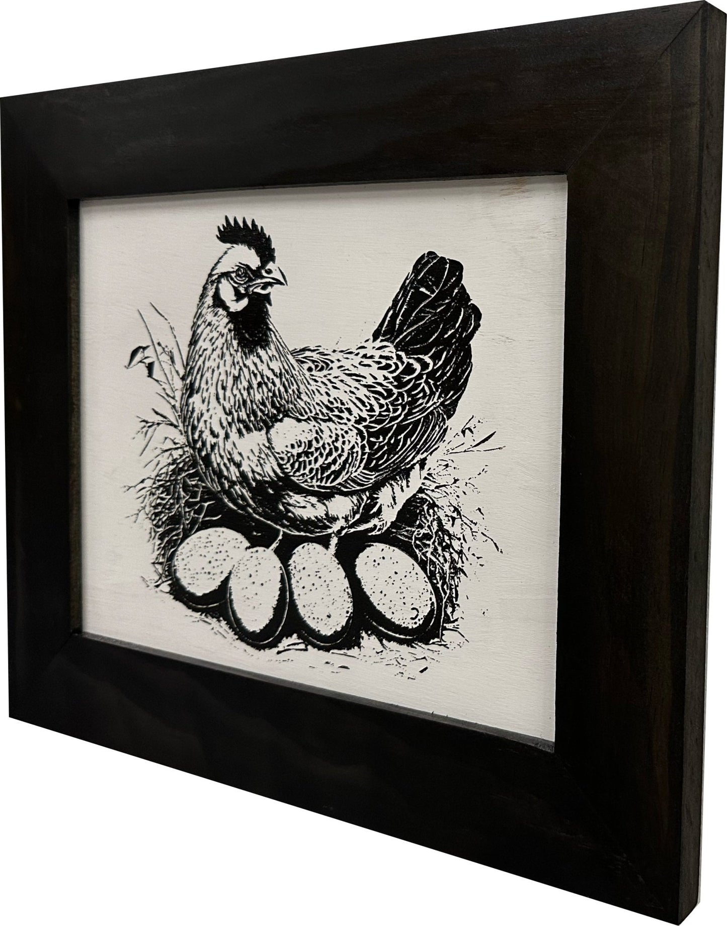 Framed artwork of a chicken with eggs on a white background
