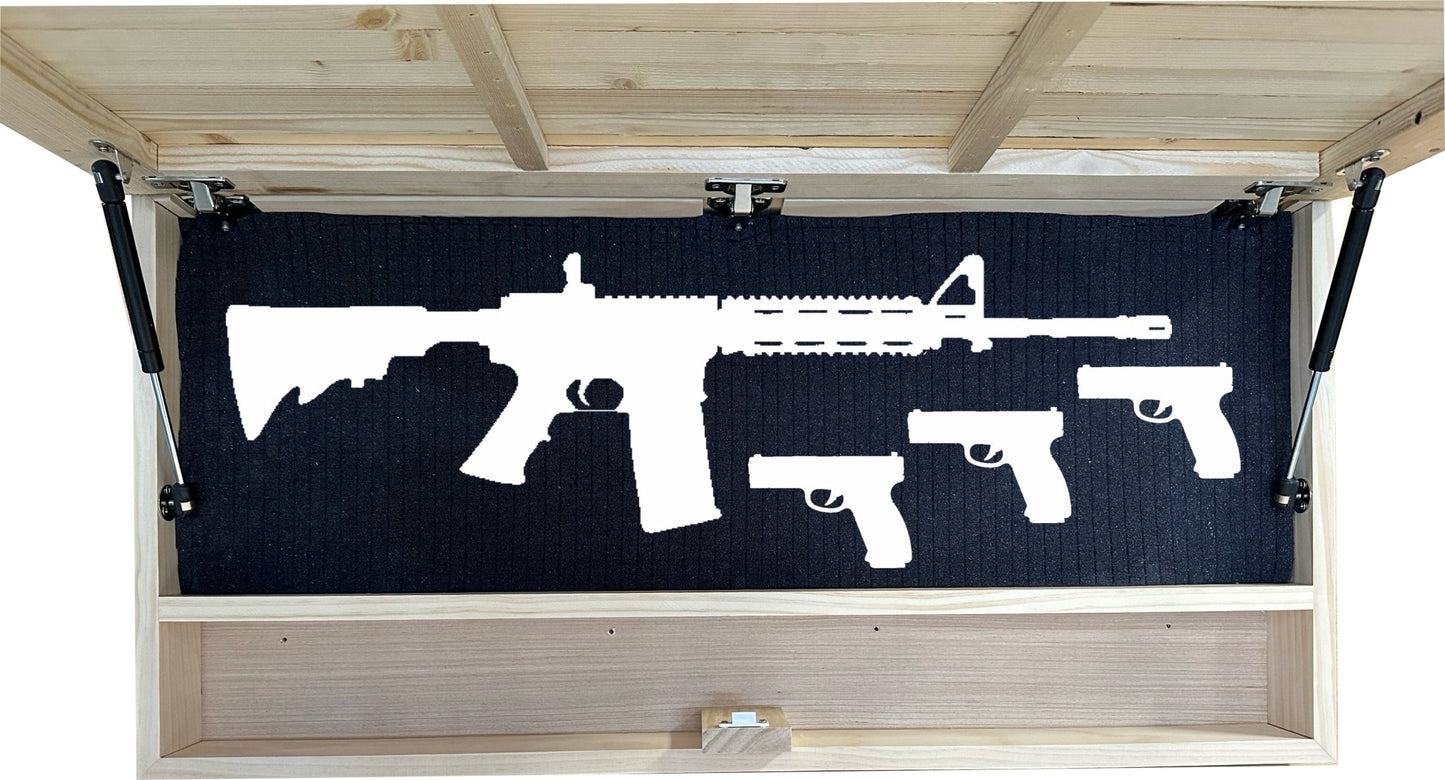 Silhouette of a rifle and two pistols on a black mat inside an open wooden cabinet.