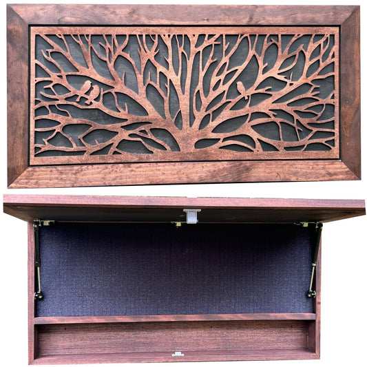 Wooden cabinet with decorative tree design on the door, open to reveal a dark interior.