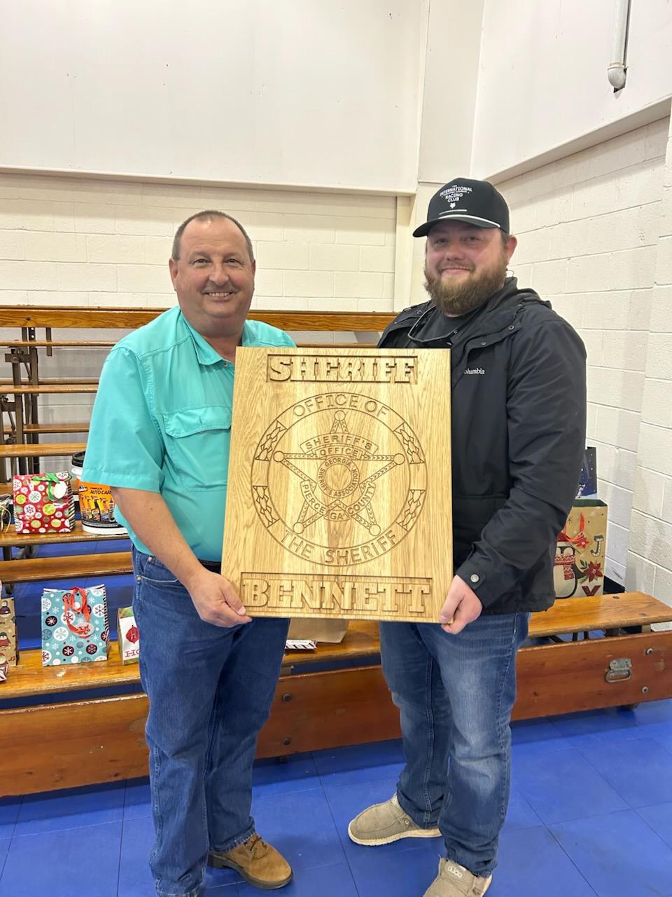 Deputy giving gift to Sheriff